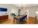 Dining room with hardwood floors, blue chairs, stylish light fixture, and contemporary art at 1256 Spring Valley Ne Ln, Atlanta, GA 30306