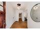 Bright entryway featuring gleaming hardwood floors and elegant lighting fixture at 1256 Spring Valley Ne Ln, Atlanta, GA 30306