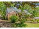 Well-maintained brick home with a lush yard, mature trees, and a charming covered porch at 1256 Spring Valley Ne Ln, Atlanta, GA 30306