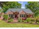 Charming red brick house with manicured lawn, mature landscaping, and inviting front entrance at 1256 Spring Valley Ne Ln, Atlanta, GA 30306