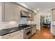 Stylish kitchen featuring stainless steel appliances, light cabinets, and tile backsplash at 1256 Spring Valley Ne Ln, Atlanta, GA 30306
