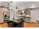 Modern kitchen with stainless steel appliances, island with sink and seating, and wood floors at 1256 Spring Valley Ne Ln, Atlanta, GA 30306