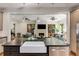 Kitchen island with sink and stainless dishwasher overlooking living room with fireplace at 1256 Spring Valley Ne Ln, Atlanta, GA 30306