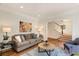 Cozy living room featuring neutral-toned sofa and stylish decor leading to staircase at 1256 Spring Valley Ne Ln, Atlanta, GA 30306
