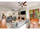 Comfortable living room with fireplace and wooden doors to backyard at 1256 Spring Valley Ne Ln, Atlanta, GA 30306
