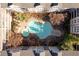 Aerial view of a pristine pool and spa surrounded by apartments, sun-drenched patio, and lush trees at 1850 Cotillion Dr # 4204, Dunwoody, GA 30338