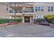Inviting building entrance with manicured landscaping, benches, and secure gate providing a welcoming arrival at 1850 Cotillion Dr # 4204, Dunwoody, GA 30338