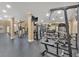 Well-equipped gym with weight machines, free weights, TV, mirrored wall, and rubber flooring at 1850 Cotillion Dr # 4204, Dunwoody, GA 30338