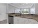 Kitchen with granite counters open to living space and view to the outside at 1850 Cotillion Dr # 4204, Dunwoody, GA 30338