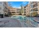 Gorgeous pool area with lounge chairs and shade, set amidst beautiful landscaping and architecture at 1850 Cotillion Dr # 4204, Dunwoody, GA 30338