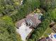Expansive aerial view showcasing a luxurious home, driveway, and surrounding lush greenery, offering privacy at 2120 Blackheath Trce, Alpharetta, GA 30005