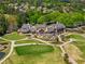 Stunning aerial view of a clubhouse overlooking a meticulously manicured golf course and surrounding community at 2120 Blackheath Trce, Alpharetta, GA 30005