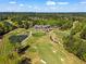 Expansive aerial of the golf course, clubhouse, and verdant landscape, showcasing the community's amenities and natural beauty at 2120 Blackheath Trce, Alpharetta, GA 30005