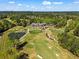 Stunning aerial view of a lush golf course with a beautiful clubhouse and scenic landscaping at 2120 Blackheath Trce, Alpharetta, GA 30005
