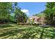 Spacious backyard with lush green lawn, pool, and beautiful landscaping at 2120 Blackheath Trce, Alpharetta, GA 30005