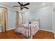 Cozy bedroom featuring hardwood floors, neutral paint, and windows dressed in curtains at 2120 Blackheath Trce, Alpharetta, GA 30005