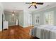 Bright bedroom with hardwood floors, fresh paint, two large windows, and ensuite bathroom at 2120 Blackheath Trce, Alpharetta, GA 30005