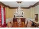 Elegant dining room with hardwood floors, chandelier, and neutral curtains, perfect for formal dinners at 2120 Blackheath Trce, Alpharetta, GA 30005