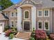 Handsome brick home featuring an arched entryway and manicured landscaping at 2120 Blackheath Trce, Alpharetta, GA 30005