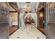 Grand foyer featuring marble flooring, wrought iron staircase, and ornate chandelier, radiating elegance at 2120 Blackheath Trce, Alpharetta, GA 30005