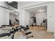 Home gym includes workout equipment, mirrors, and tiled flooring at 2120 Blackheath Trce, Alpharetta, GA 30005