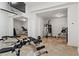 Well-equipped home gym with mirrored wall and a variety of exercise equipment for a complete workout at 2120 Blackheath Trce, Alpharetta, GA 30005