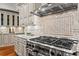 Close-up of the kitchen's stainless steel range, granite countertops, and stylish backsplash at 2120 Blackheath Trce, Alpharetta, GA 30005