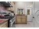 This kitchen features granite countertops, stainless steel appliances, and tile floors at 2120 Blackheath Trce, Alpharetta, GA 30005