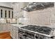 This kitchen features granite countertops, stainless steel appliances, and custom tile backsplash at 2120 Blackheath Trce, Alpharetta, GA 30005