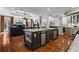 Spacious kitchen with large island, stainless steel appliances, and adjacent living area at 2120 Blackheath Trce, Alpharetta, GA 30005