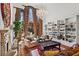 Bright living room features soaring windows, a chandelier, fireplace, and built-in shelving at 2120 Blackheath Trce, Alpharetta, GA 30005