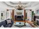 Elegant living room featuring a fireplace, chandelier, and access to outdoor spaces at 2120 Blackheath Trce, Alpharetta, GA 30005