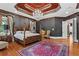 Comfortable main bedroom with hardwood floors, four-poster bed, and a view of the window at 2120 Blackheath Trce, Alpharetta, GA 30005