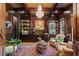 Sophisticated office with dark wood paneling, custom shelving and a chandelier at 2120 Blackheath Trce, Alpharetta, GA 30005