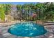 In ground pool and stone patio surrounded by mature trees and foliage at 2120 Blackheath Trce, Alpharetta, GA 30005