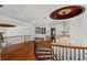 Hallway on the second floor with hardwood floors, a chandelier, and views of the downstairs foyer at 2120 Blackheath Trce, Alpharetta, GA 30005