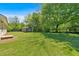 Side view of house with a storage shed and trees in the yard at 63 Seminole Ne Rd, Cartersville, GA 30121