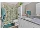 Bathroom with granite countertop, vanity, green accents, and shower with plant-themed curtain at 63 Seminole Ne Rd, Cartersville, GA 30121