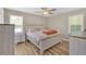Bedroom with wood-look floors, ceiling fan, and natural light from the two windows at 63 Seminole Ne Rd, Cartersville, GA 30121
