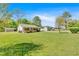Charming exterior view of house and detached garages on large grassy lawn under sunny skies at 63 Seminole Ne Rd, Cartersville, GA 30121