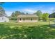 View of the home's exterior and lush green lawn, with a storage shed in the background at 63 Seminole Ne Rd, Cartersville, GA 30121