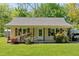 Charming home exterior with covered porch, mature landscaping, and well-manicured front lawn at 63 Seminole Ne Rd, Cartersville, GA 30121