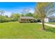Exterior view of the property with a well-maintained front yard, mature trees and paved driveway at 63 Seminole Ne Rd, Cartersville, GA 30121
