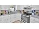 Kitchen featuring white cabinets, stainless steel appliances, and modern backsplash at 63 Seminole Ne Rd, Cartersville, GA 30121
