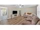 Cozy living room with ceiling fan, wood-look flooring and view into the kitchen at 63 Seminole Ne Rd, Cartersville, GA 30121