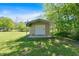 A utility shed with a roll up door and a concrete pad at 63 Seminole Ne Rd, Cartersville, GA 30121