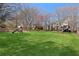 Spacious backyard features mature trees, swing set, and lush green lawn at 720 Lakeglen Dr, Suwanee, GA 30024