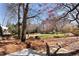Extensive backyard space with a stepping stone path amongst trees and natural foliage at 720 Lakeglen Dr, Suwanee, GA 30024