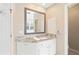 Bathroom vanity with custom cabinets, granite countertops, and a large mirror at 720 Lakeglen Dr, Suwanee, GA 30024