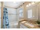 Well-lit bathroom featuring a shower-tub combo, modern vanity, and stylish mirror at 720 Lakeglen Dr, Suwanee, GA 30024